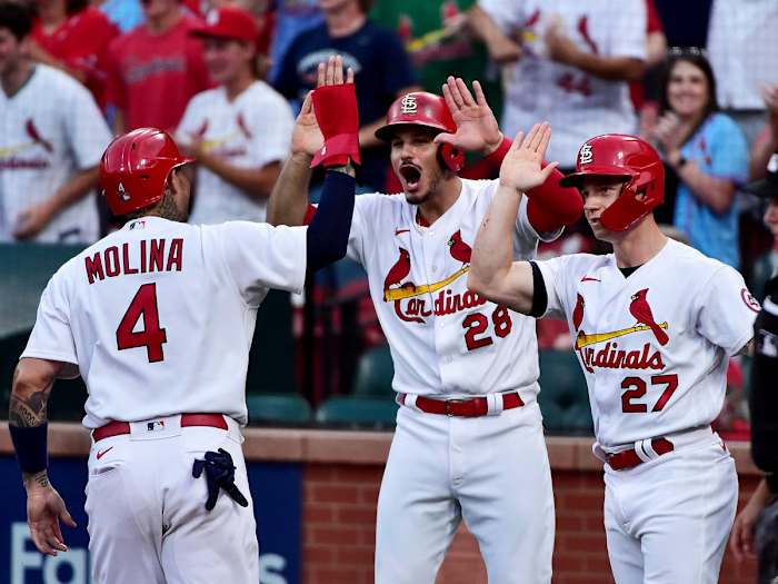 Jun 9, 2021; St. Louis, Missouri, USA;  St. Louis Cardinals third baseman Nolan Arenado (28) and left fielder Tyler O'Neill (27) and catcher Yadier Molina (4) celebrate after they scored on a double by second baseman Matt Carpenter (not pictured) during the first inning against the Cleveland Indians at Busch Stadium.